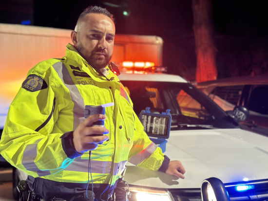 An RCMP officer operating breathalyzer equipment roadside