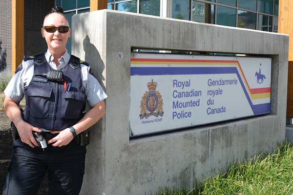 Photo of Sgt Joelle Lachance in from of RCMP sign