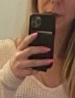 Amber Manthorne holding a black cell phone