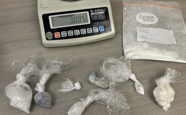 Image of scale and assorted plastic bags containing drugs 