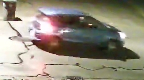 Surveillance camera image of blue car